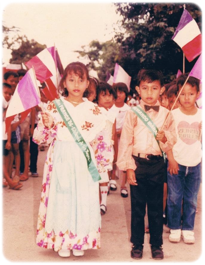 Fond memories from 3rd grade! I was the class muse then and this was taken during a parade. I believe the event was world's day or something like that. I was Ms. France and my Grandma created my costume. The floral dress was my mother's old dress then she added a white scalloped embroidered shawl and a mint green eyelet apron. The color of the flag seems off though as the purple is supposed to be blue or maybe it looks faded because the photo is quite old. Hehehehe!